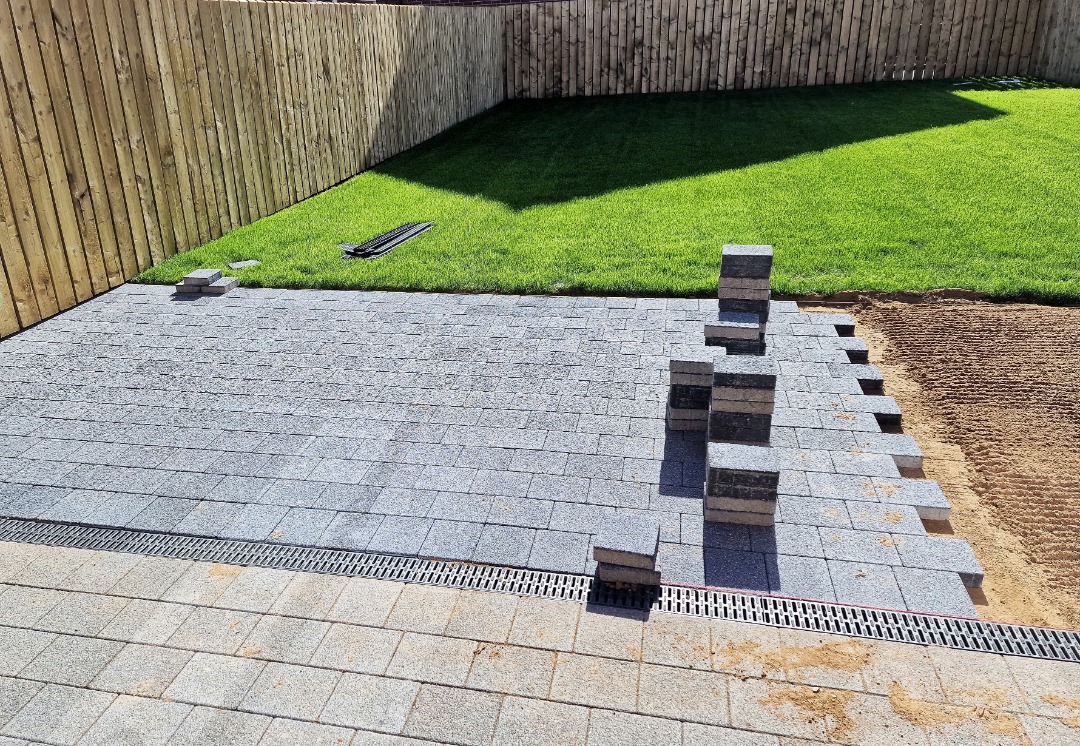 A paver patio in the process of being laid down.